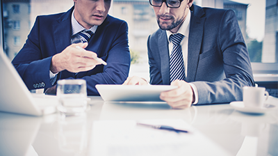 Two businessmen looking over a document